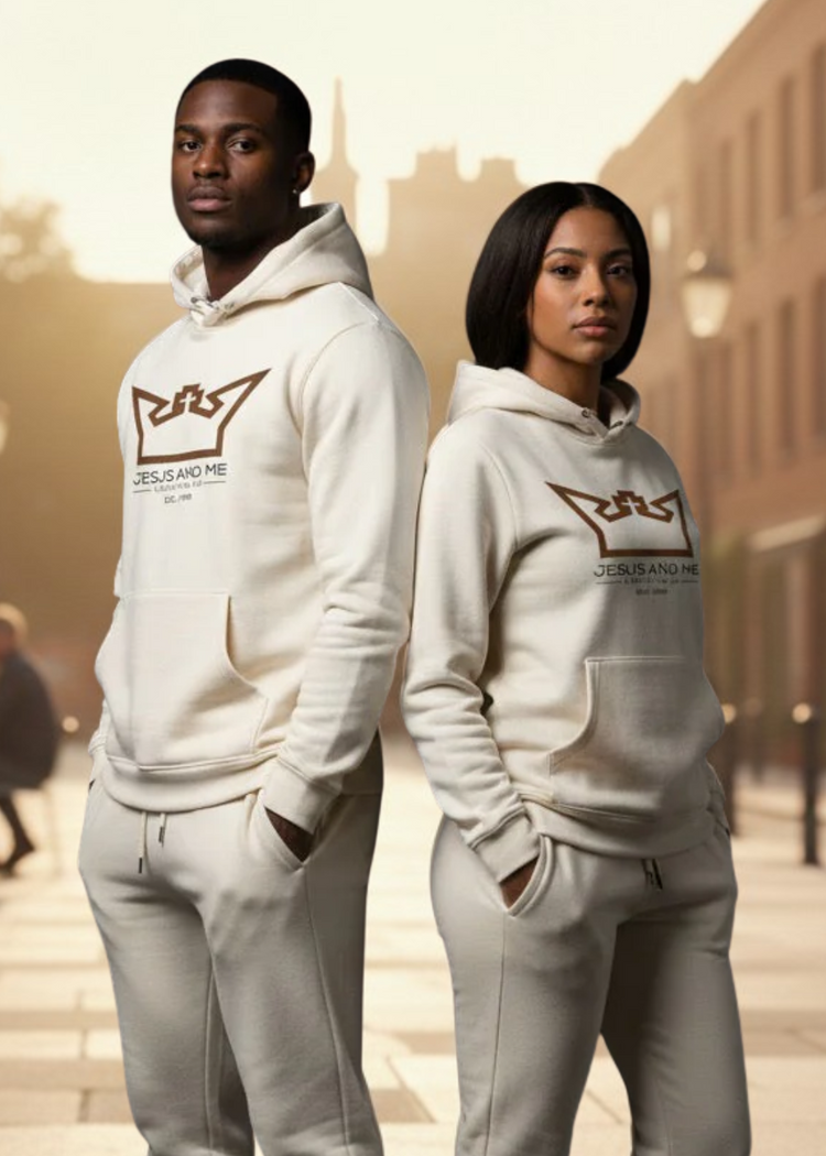 Two people wearing matching white hoodies with a logo in an urban setting.